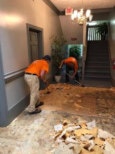Technicians Removing Moldy Floor Boards After A Flood